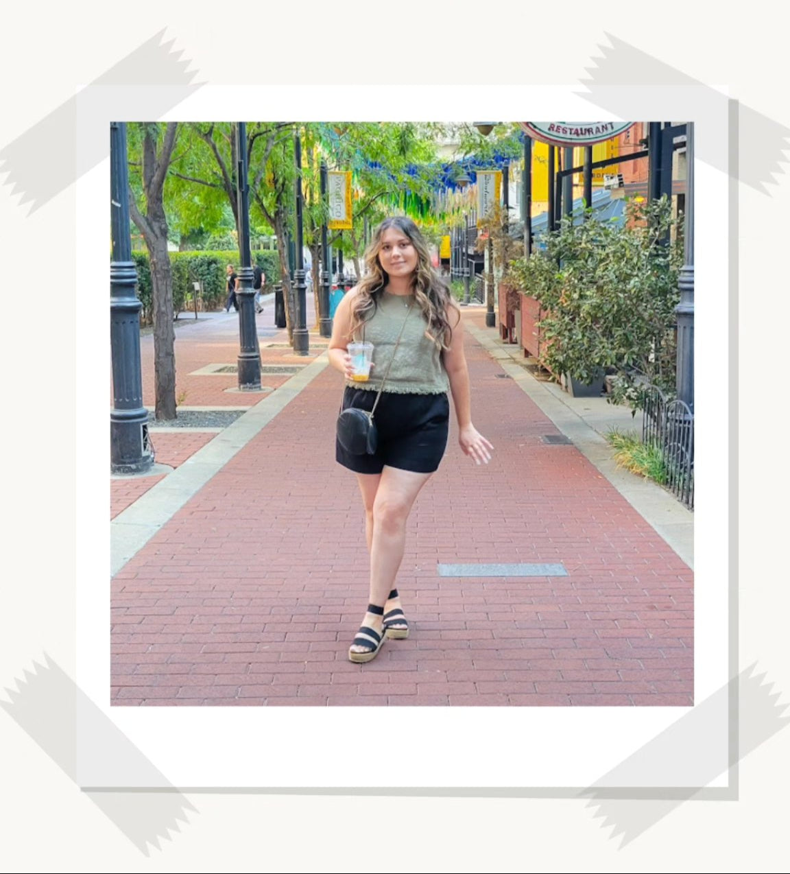 Woman walking on a sidewalk with trees and buildings in the background